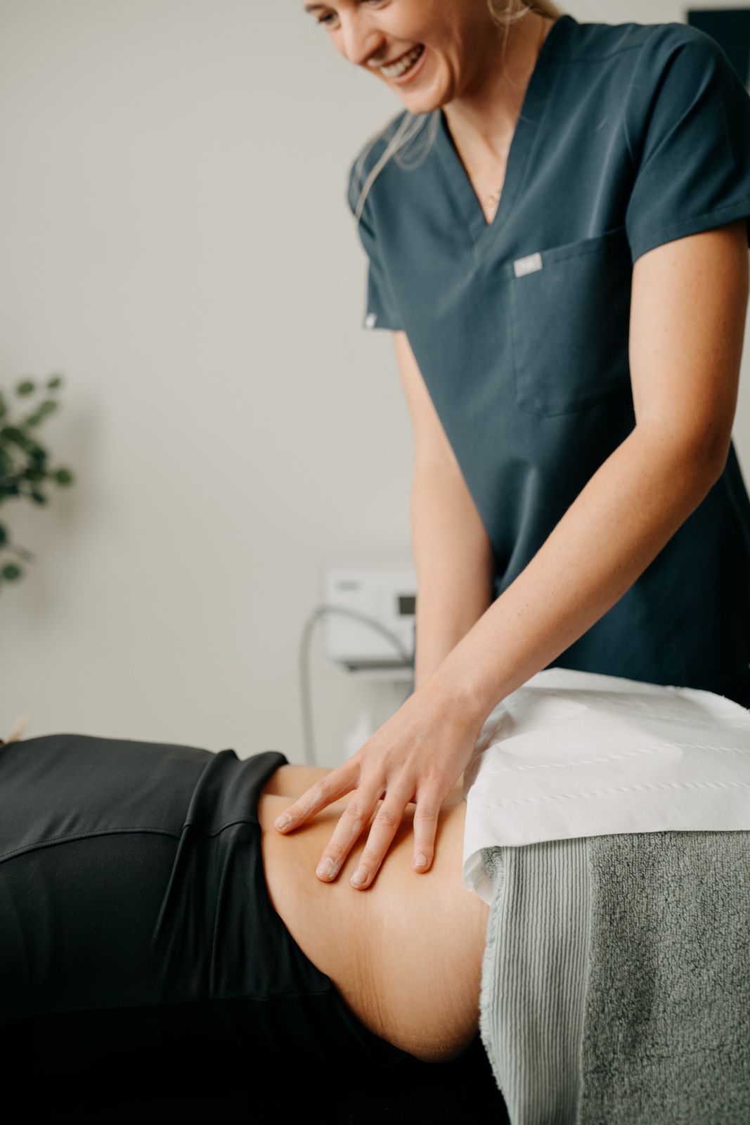Chartered physiotherapist working on a patient's knee at Assure Health, Belfast